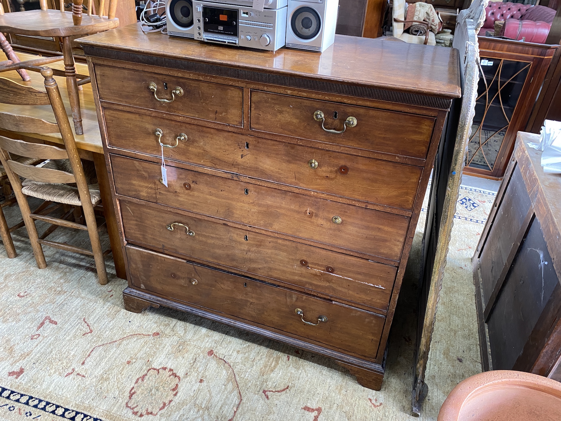 A late Georgian mahogany chest of drawers, panelled back detached, width 117cm, depth 57cm, height 119cm